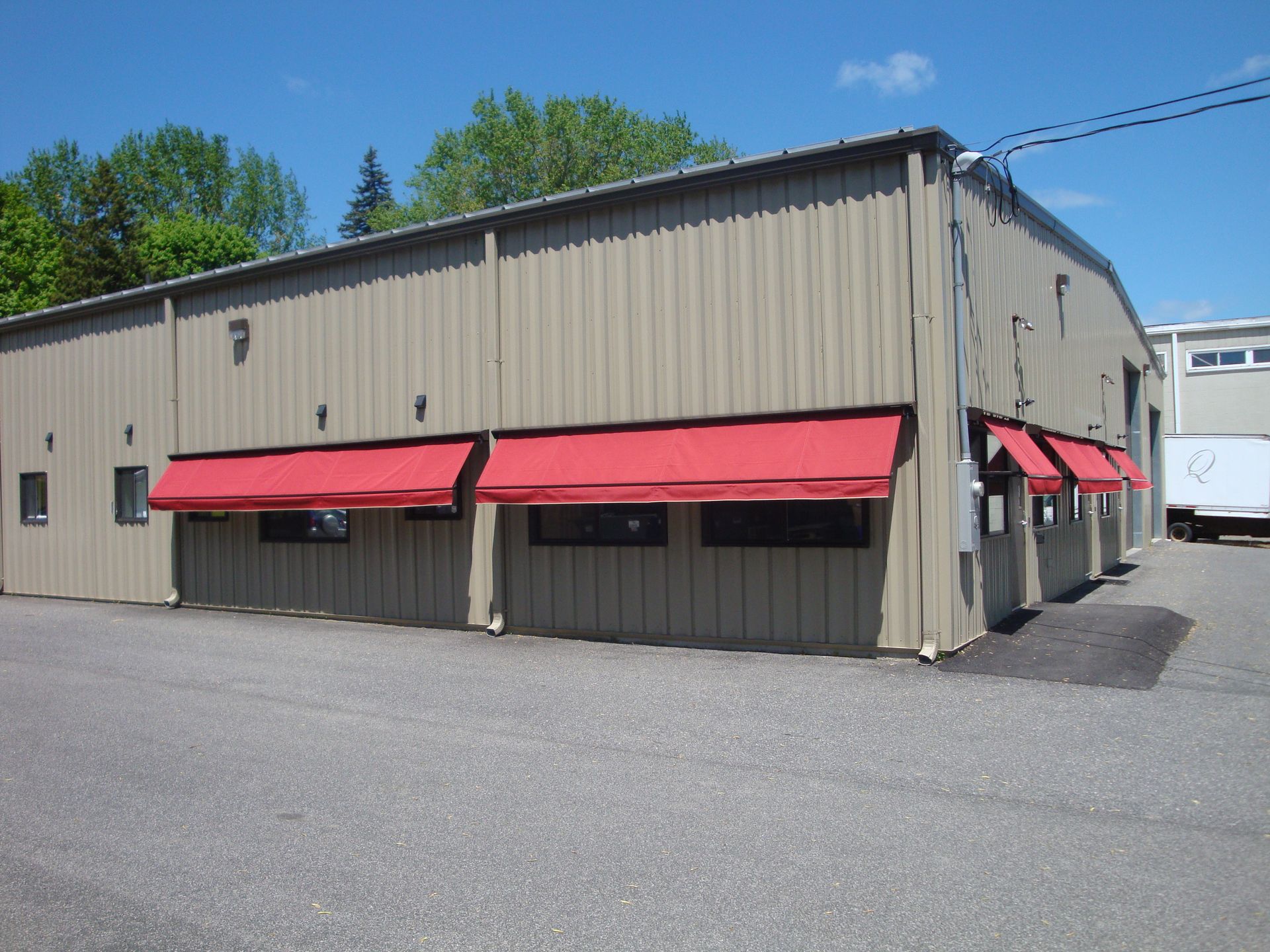 Sweet Retreat ice cream shop exterior with brown awning and stone facade.