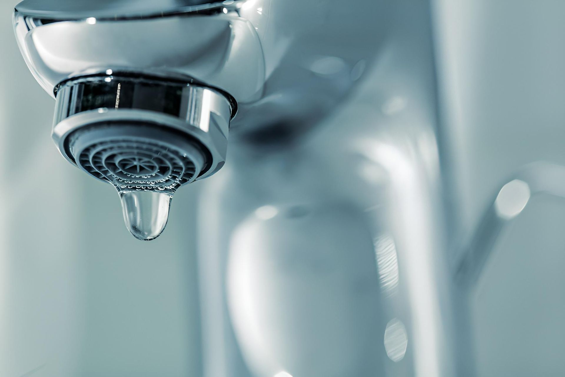 A Close Up of a Water Faucet With a Drop of Water Coming Out of It — Vision Plumbing Queensland in Pimlico, QLD