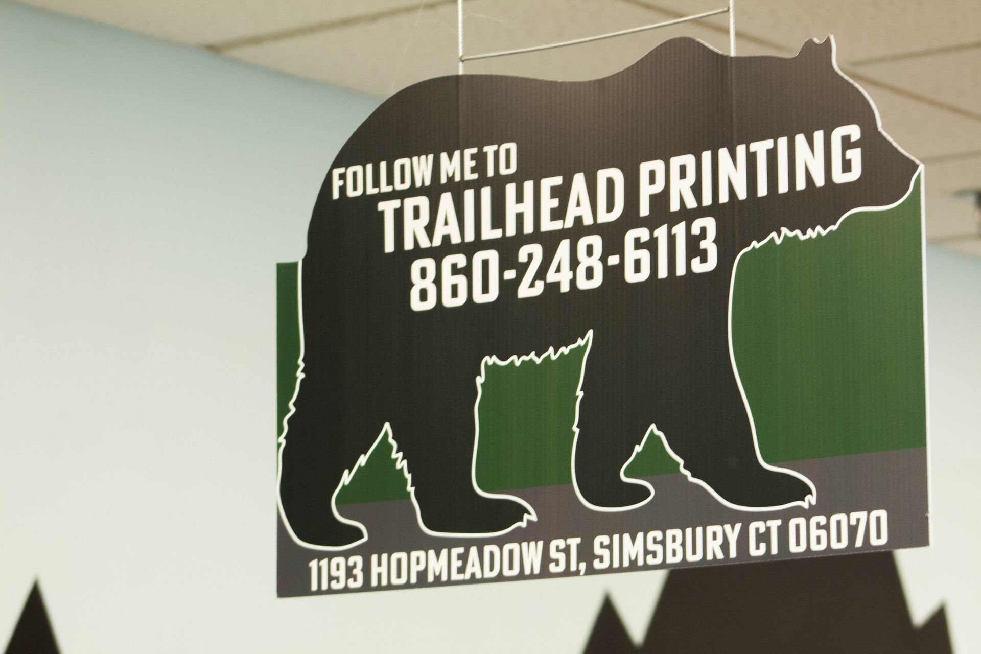 Trailhead Printing sign with phone number, green bear silhouette, and address in Simsbury, CT