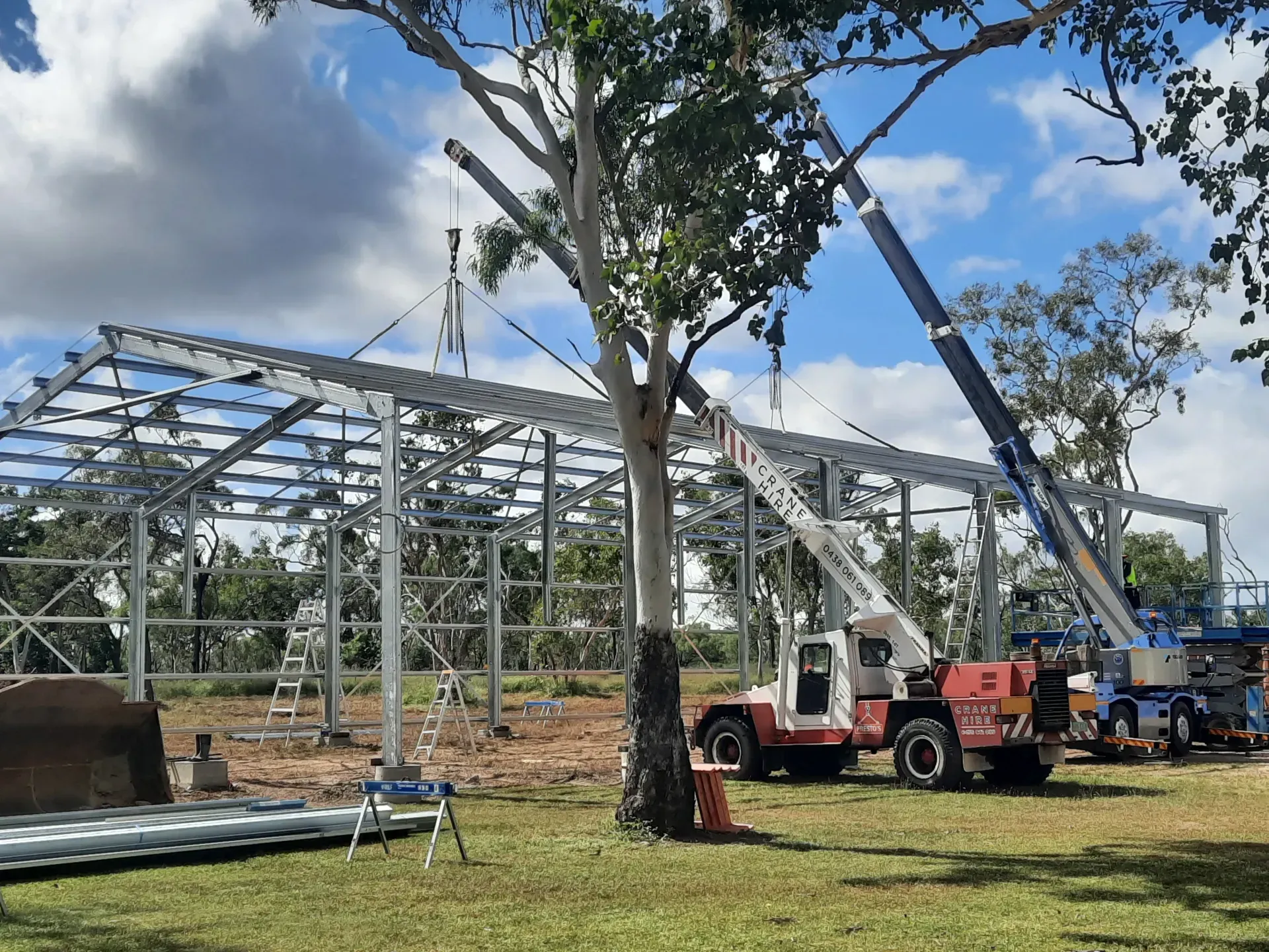 Construction Site With a Metal Frame Building Being Erected — Presto's Cranes & Rigging NQ in Garbutt, QLD