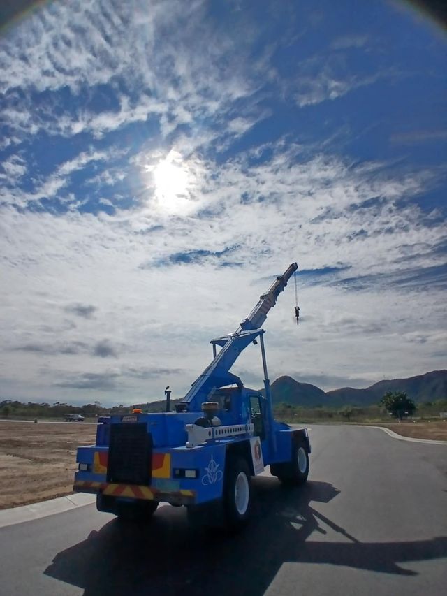 Blue Crane Truck on Road Presto's Cranes & Rigging NQ in Garbutt, QLD