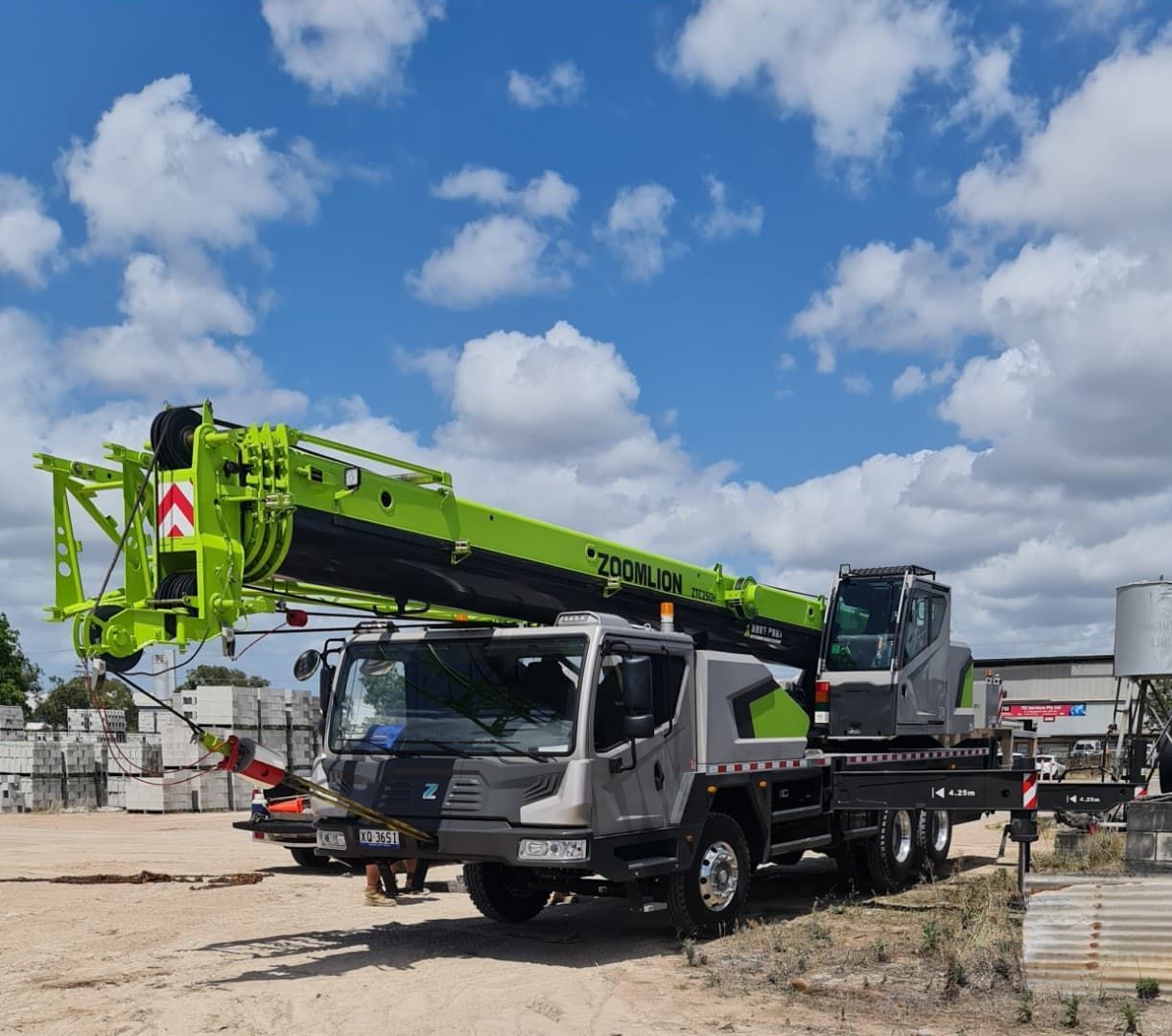 A Large Green and Gray Crane Truck Parked Outdoors — Presto's Cranes & Rigging NQ in Garbutt, QLD