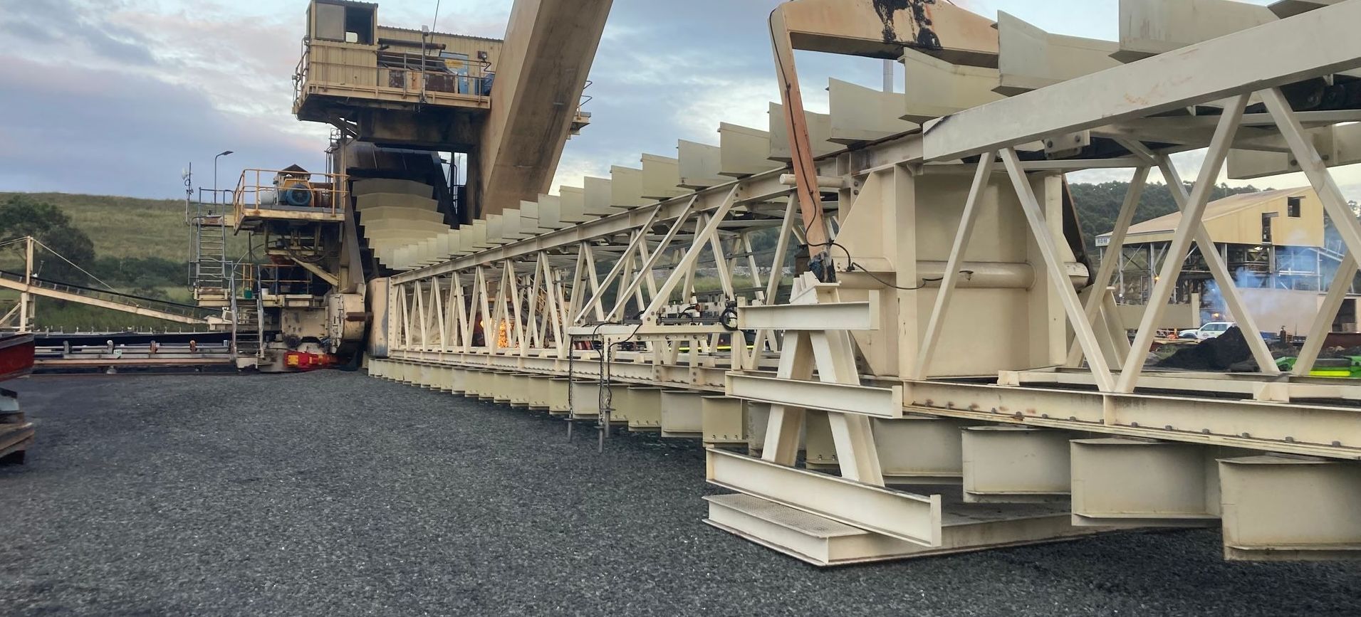 A Large Conveyor Belt Is Sitting On Top Of A Gravel Field — JMG Maintenance & Fabrication In Muswellbrook NSW