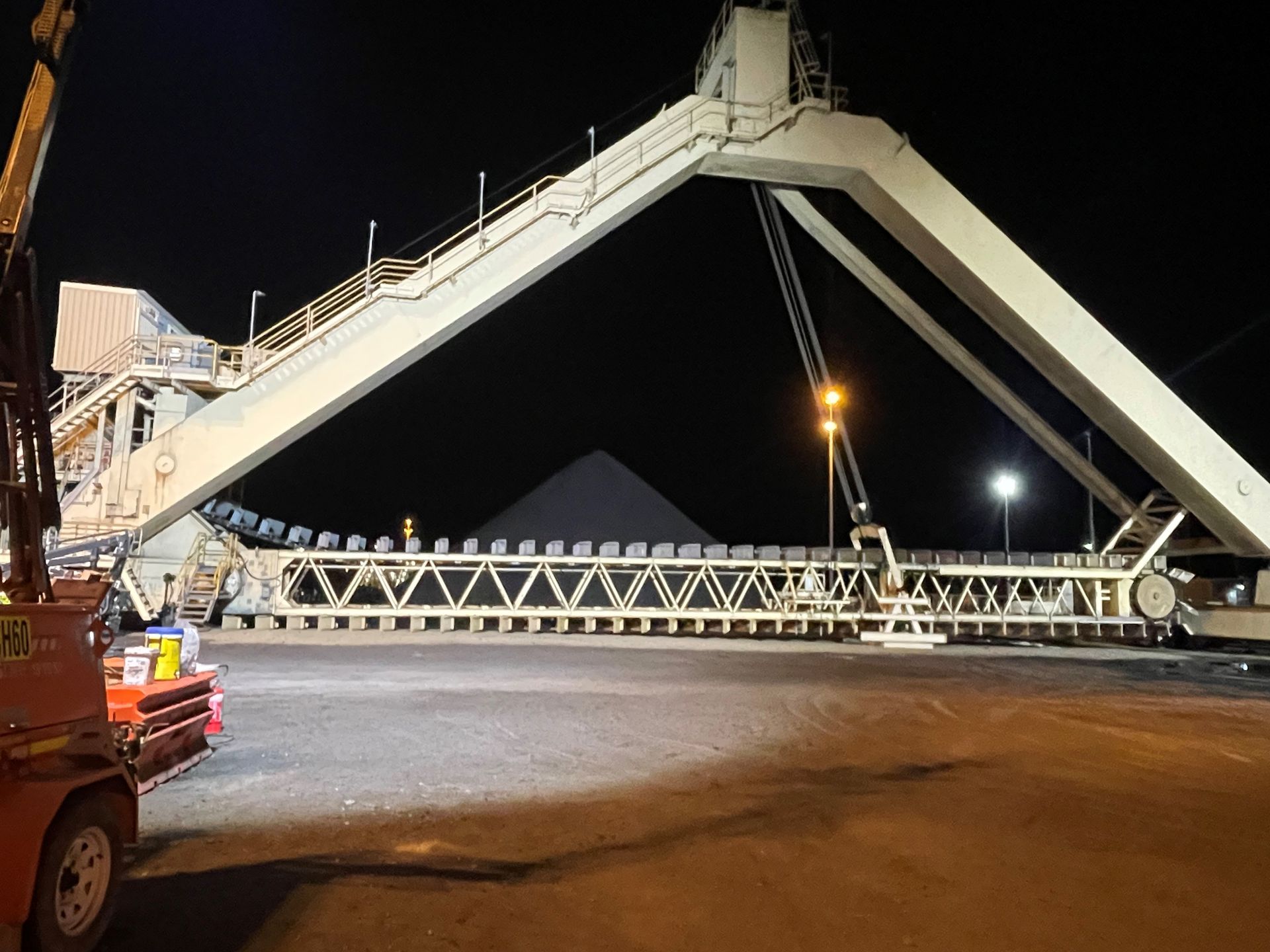 A Forklift Is Parked In Front Of A Bridge At Night — JMG Maintenance & Fabrication In Muswellbrook NSW