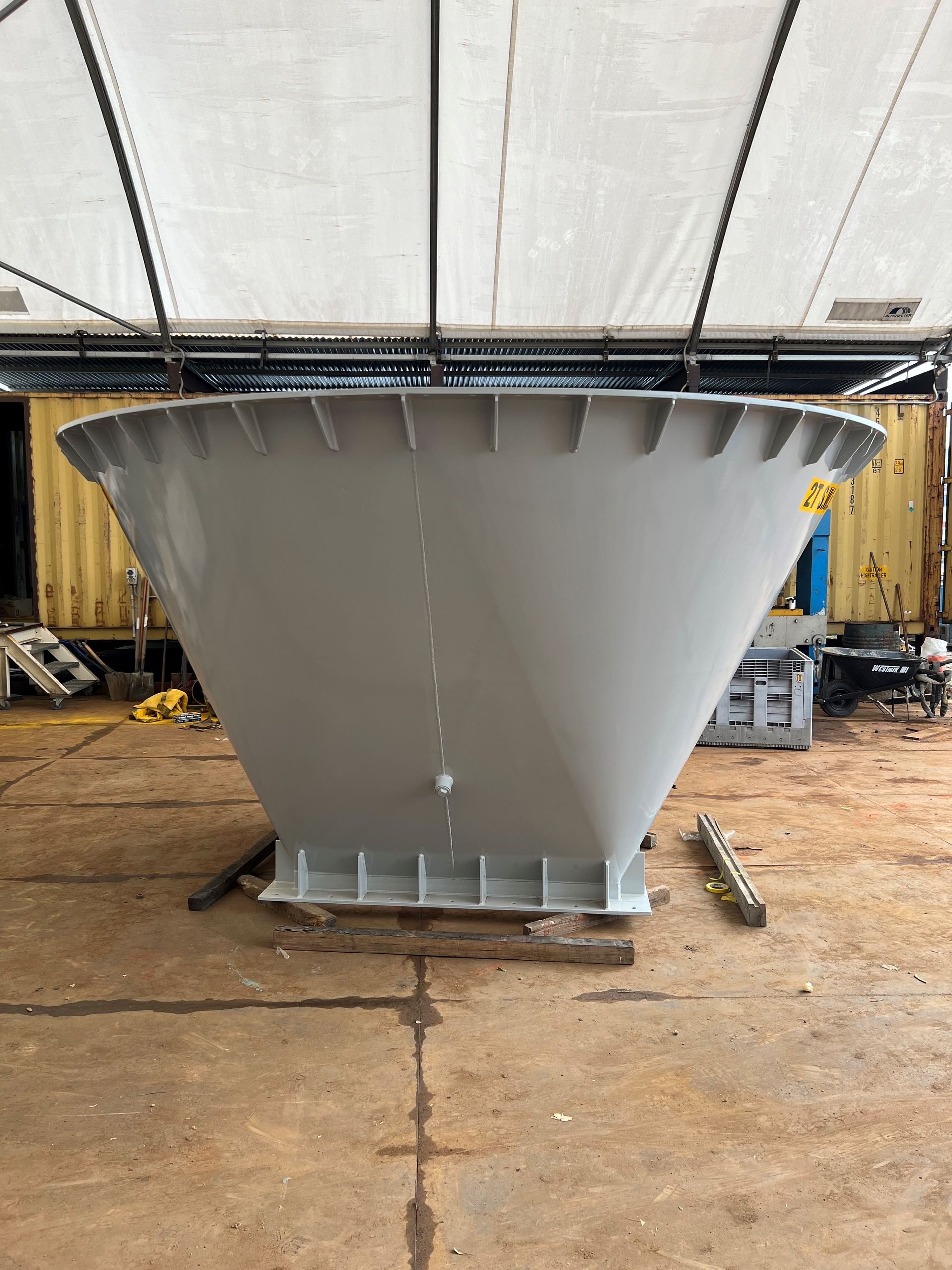 A Large White Cone Shaped Object Is Sitting On The Ground In A Warehouse — JMG Maintenance & Fabrication In Muswellbrook NSW
