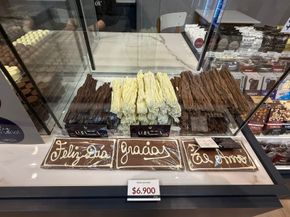 Chocolate display case with various chocolate sticks and message plaques; 
