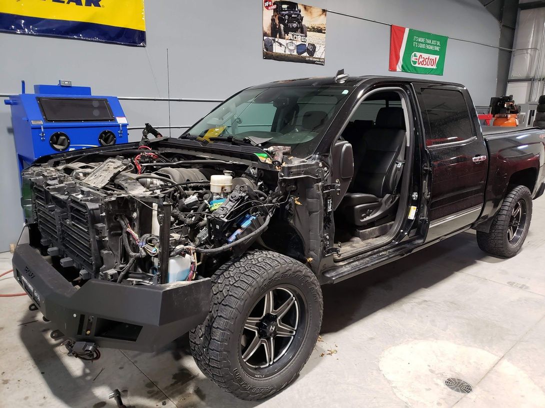 Black Truck Under Auto Repair Service | Wolfies Tire & Auto