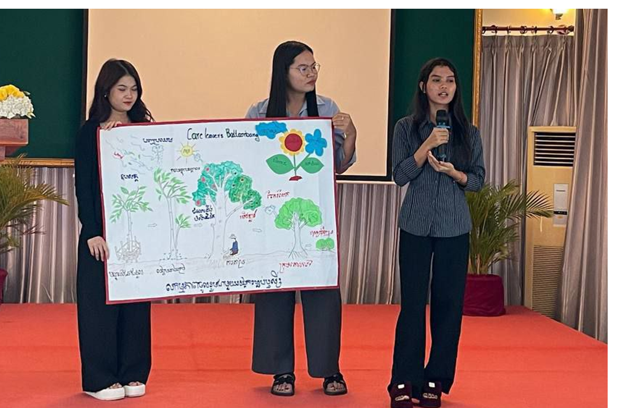 Cambodian woman giving presentation with two peers