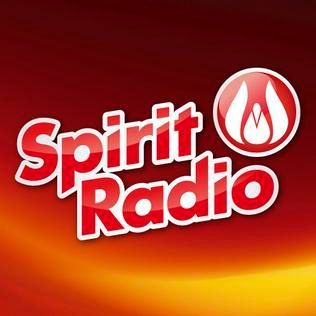 Spirit Radio logo with red text and white outline; flame emblem in circle.