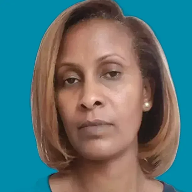 Woman with short, light brown hair; neutral expression, looking forward.