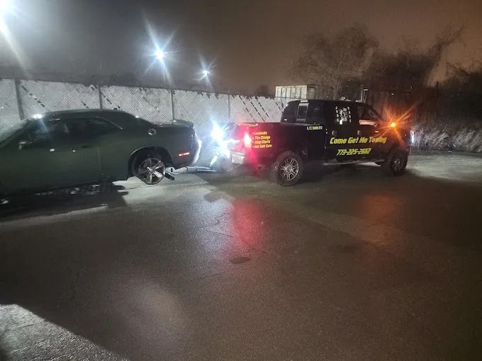 Two SUVs with flashing lights block a wet street at night, with smoke or steam in the background.