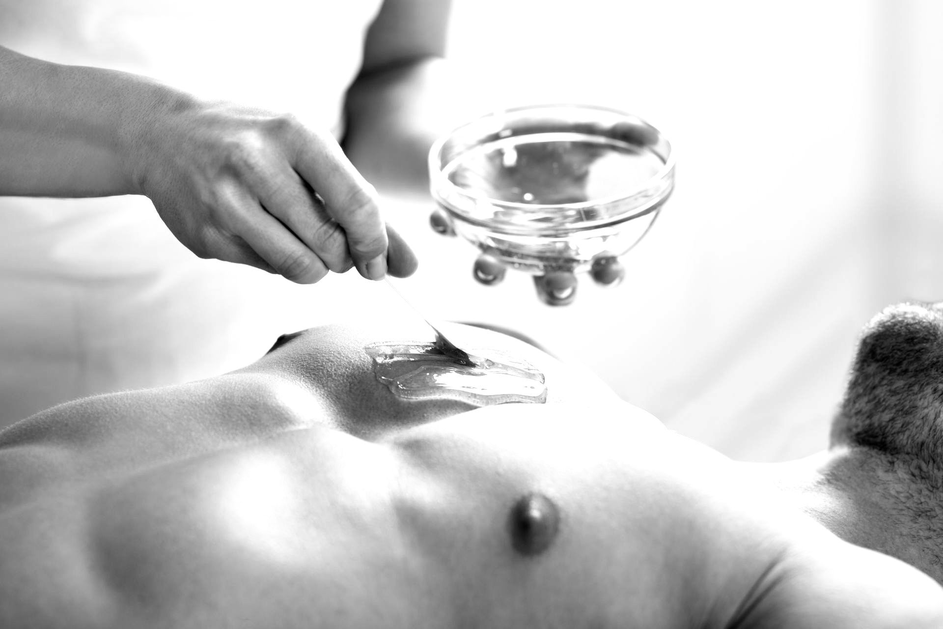 Image of a man getting his chest waxed