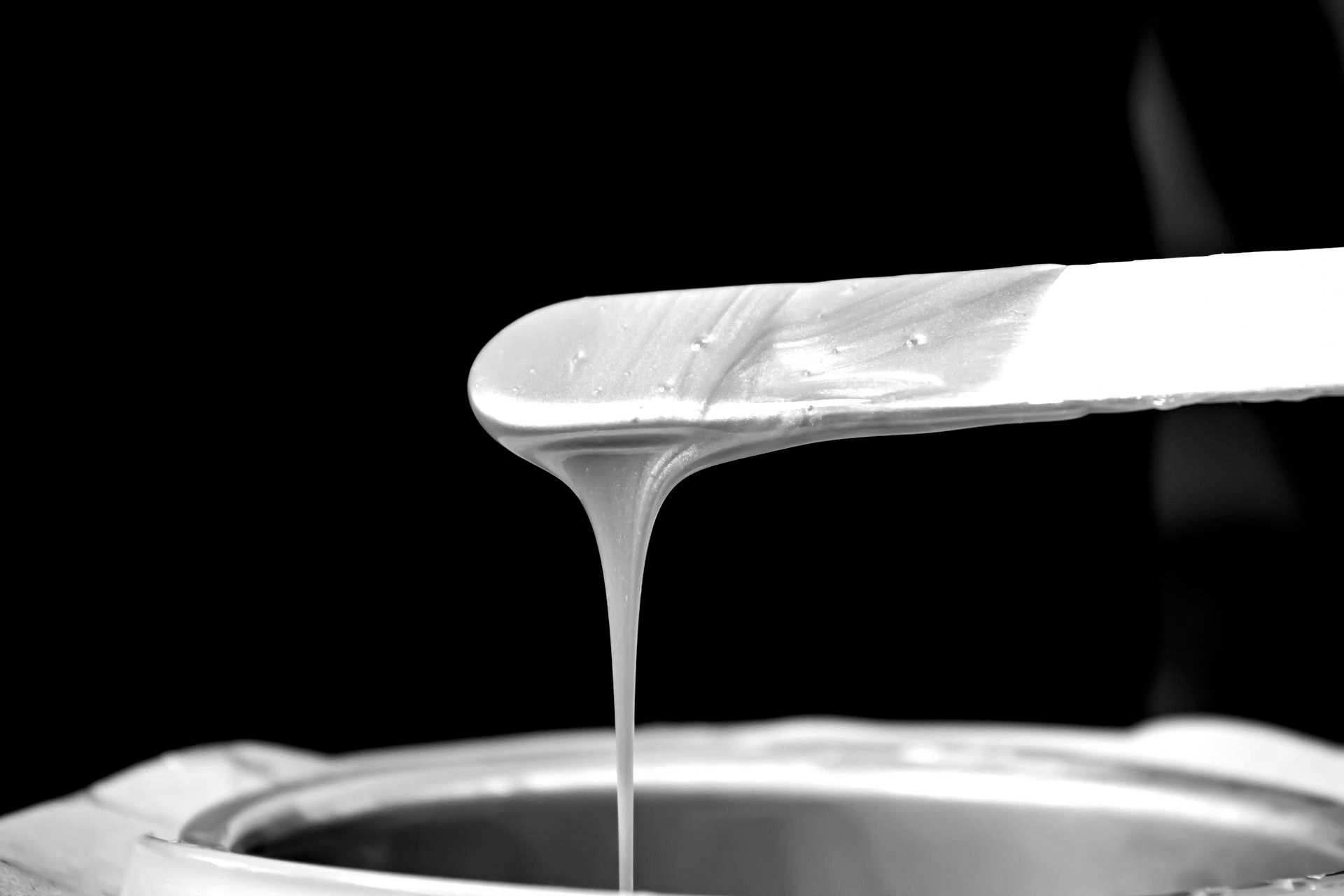 Image of hot wax dripping off an applicator