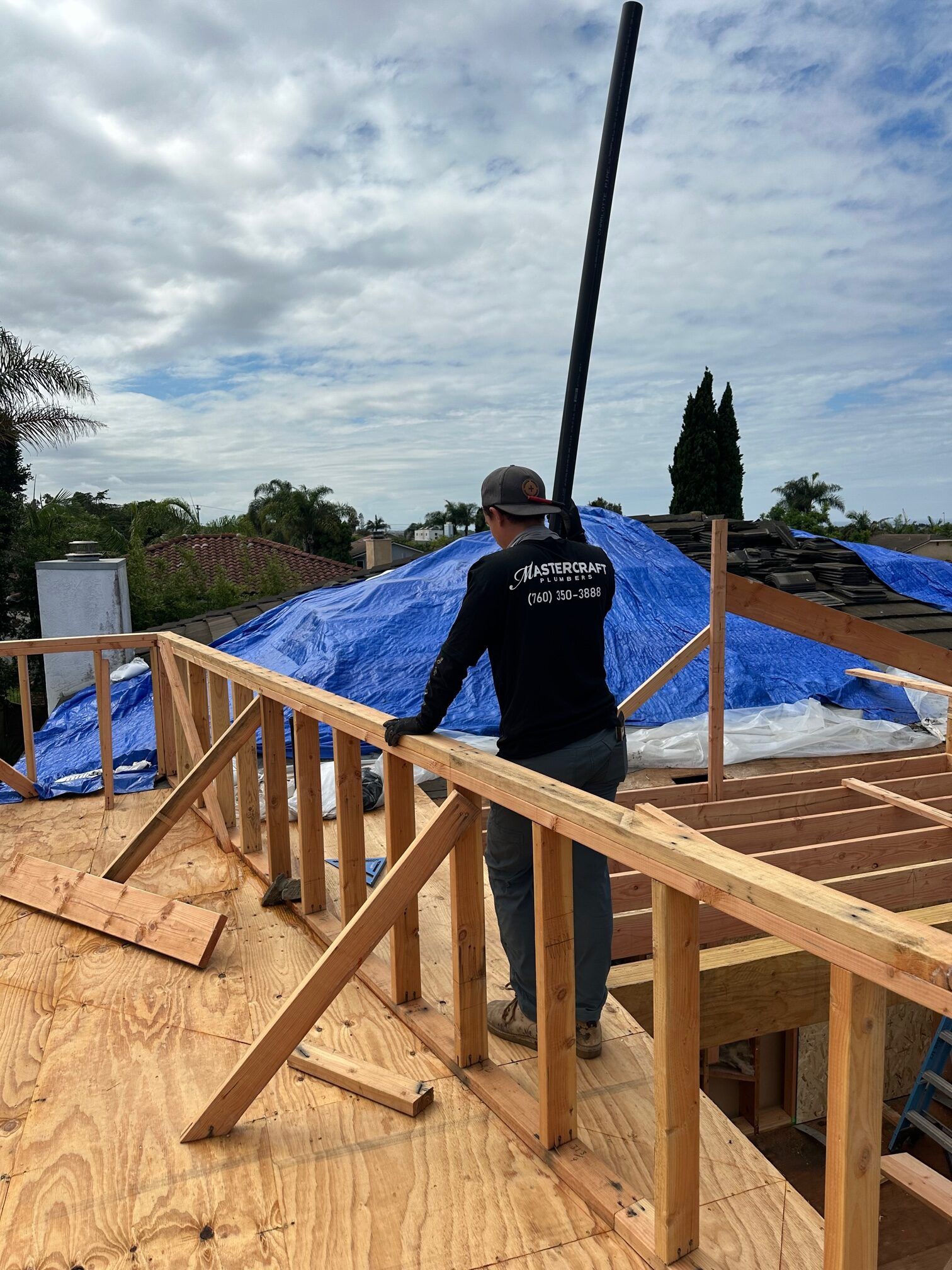A man is standing on top of a wooden structure.