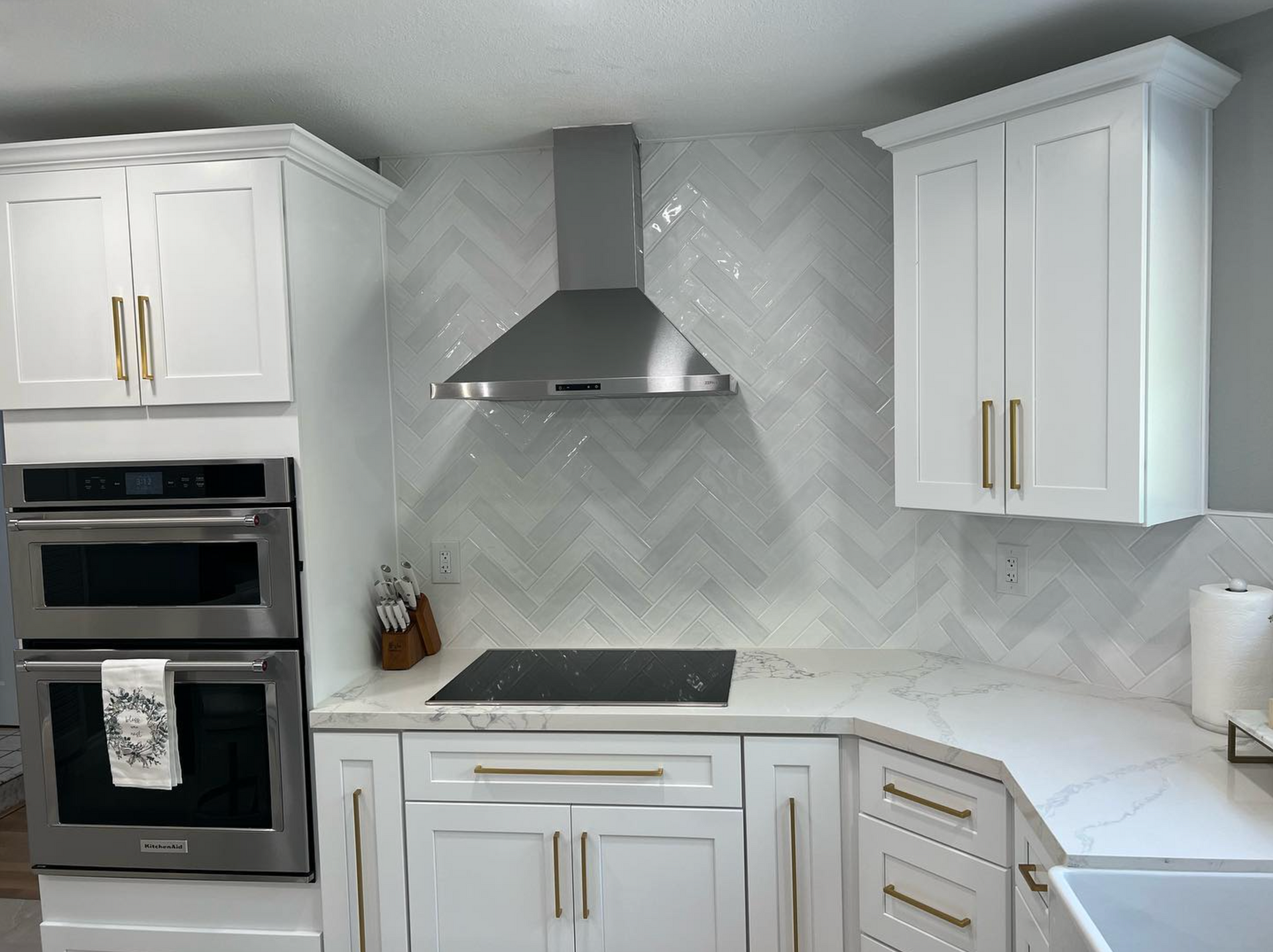 A kitchen with white cabinets and stainless steel appliances