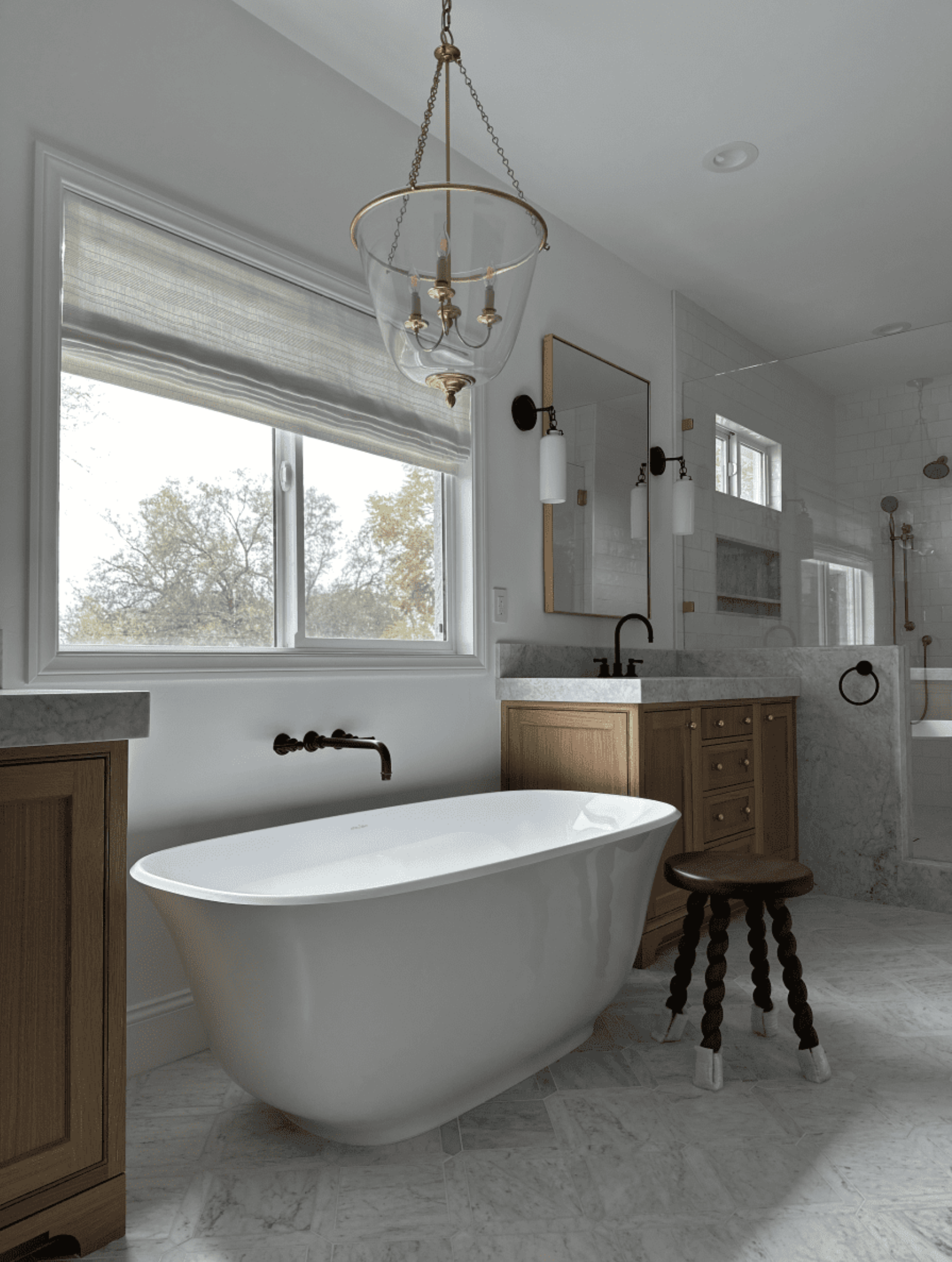 A bathroom with a bathtub , sink , mirror and window.