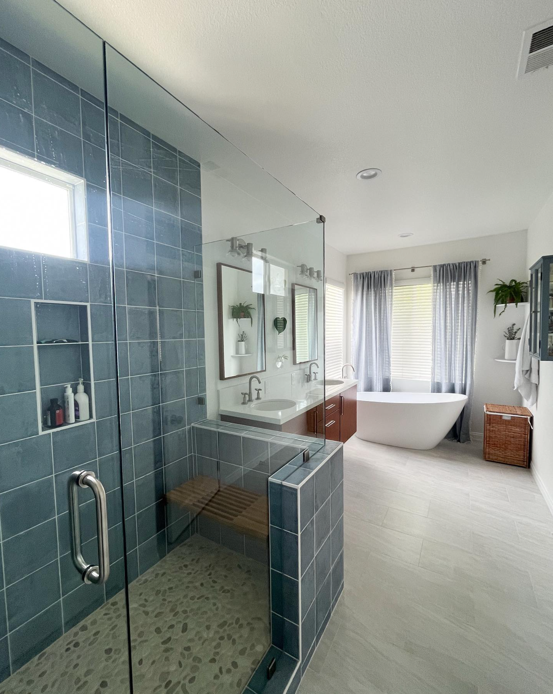A bathroom with a tub , sink , and shower.