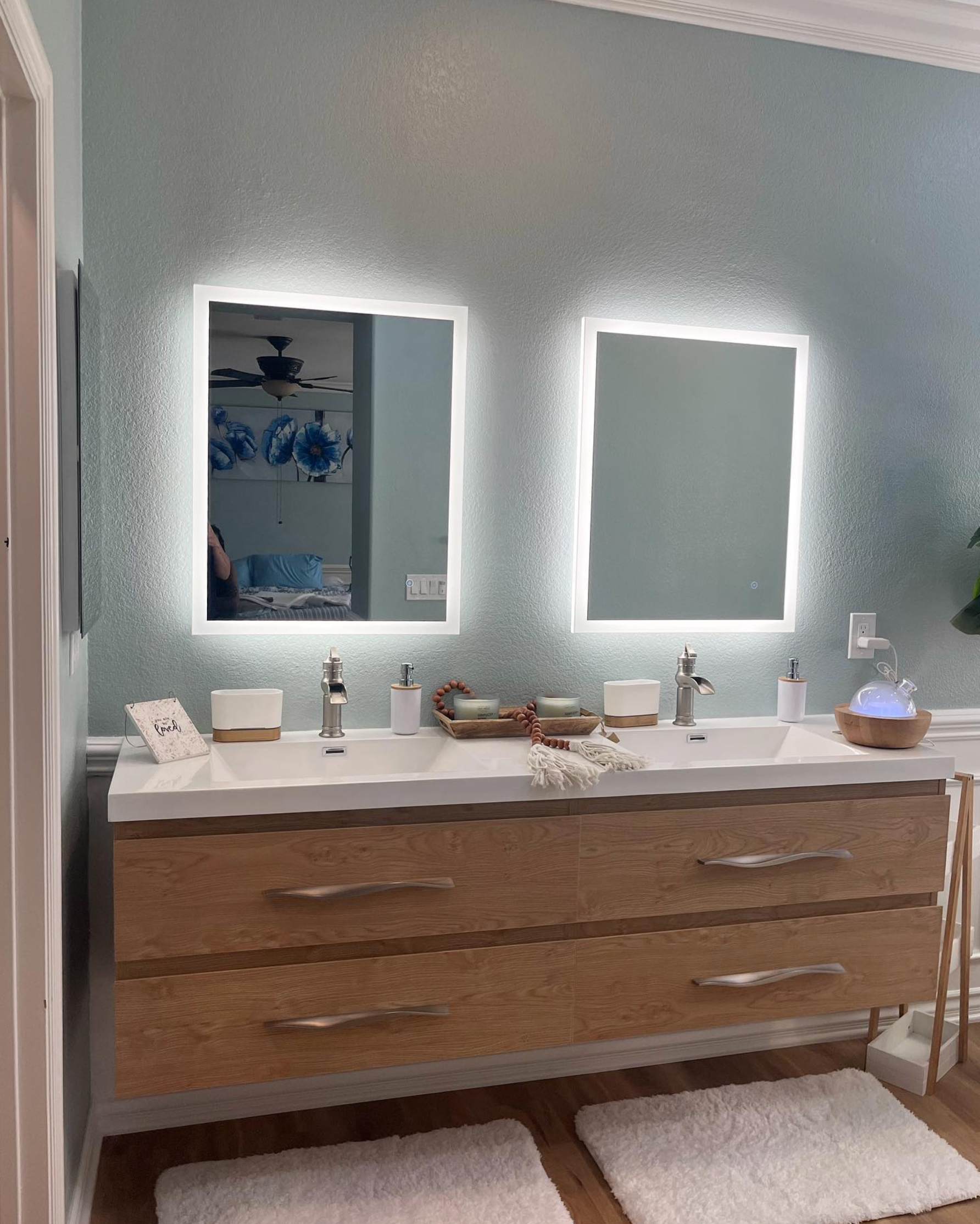 A bathroom with two sinks and two mirrors.