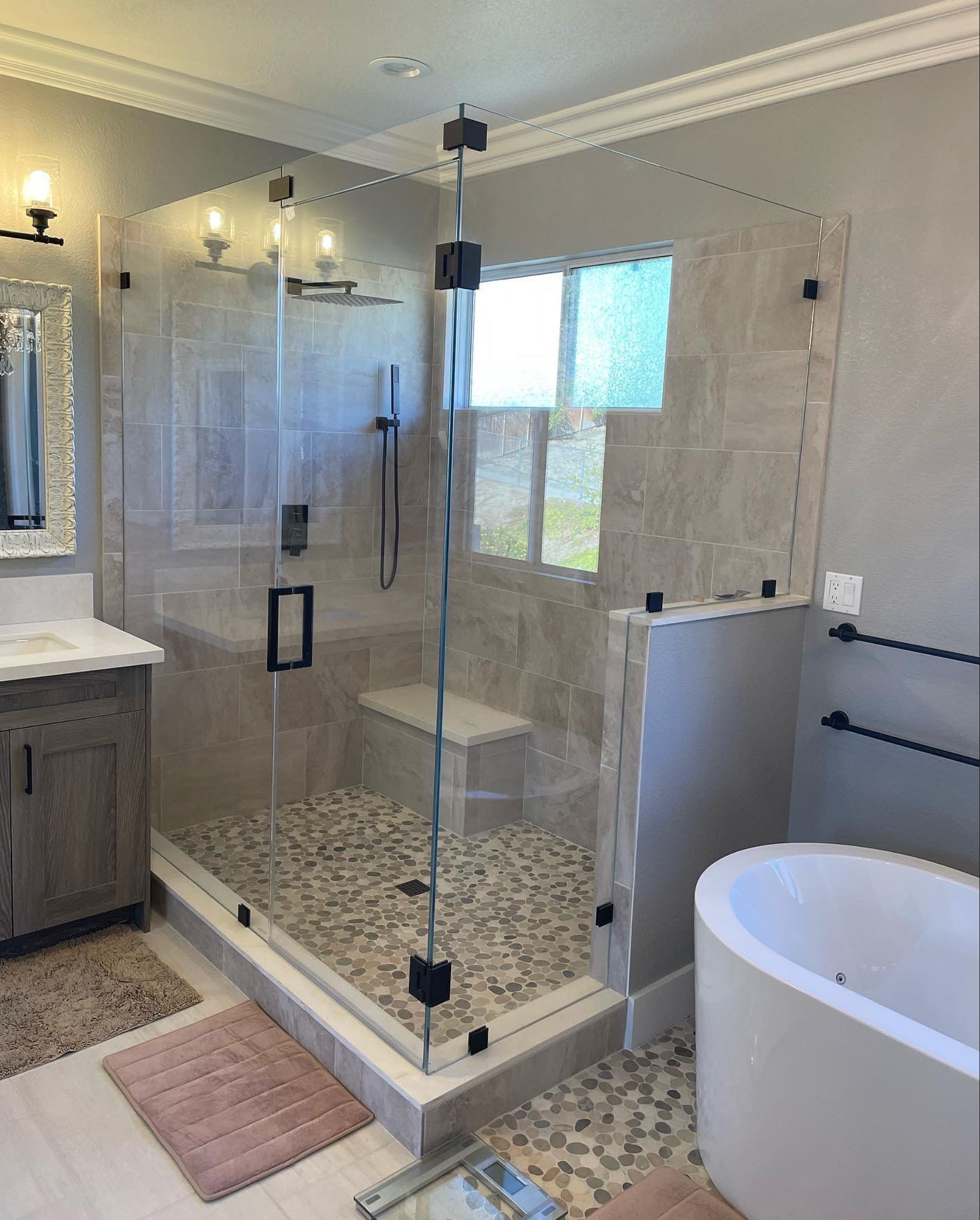 A bathroom with a walk in shower and a bathtub.