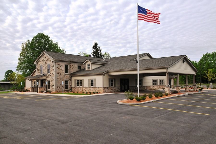 Exterior of Eernisse Funeral Homes & Cremation Service with American flag and spacious parking area