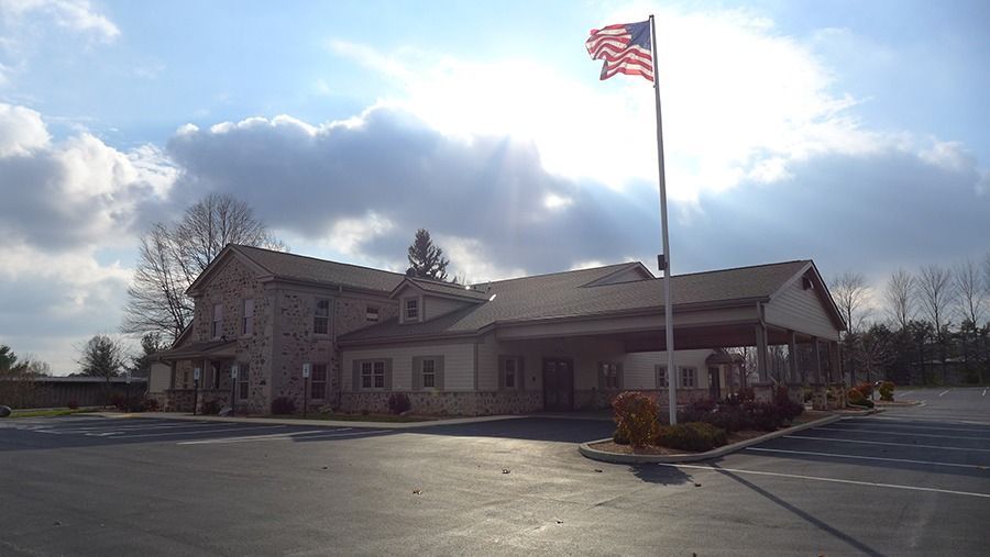 Elegant funeral home building with covered entrance and calm surroundings for families and memorial gatherings
