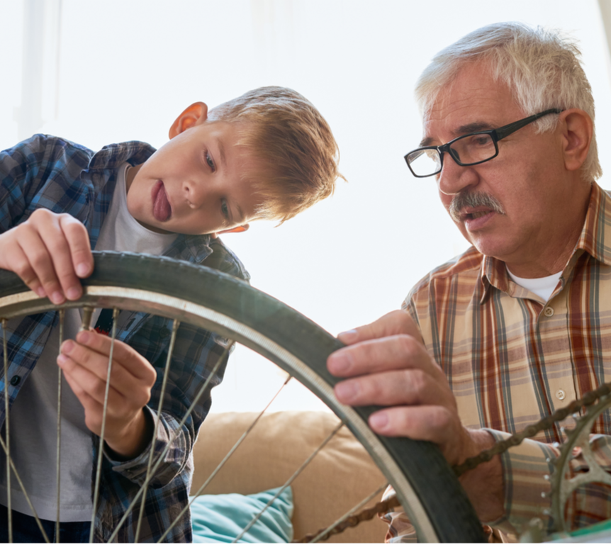 A man is sitting on a couch in a living room. SIL – Supported Independent Living, NDIS, Canberra.