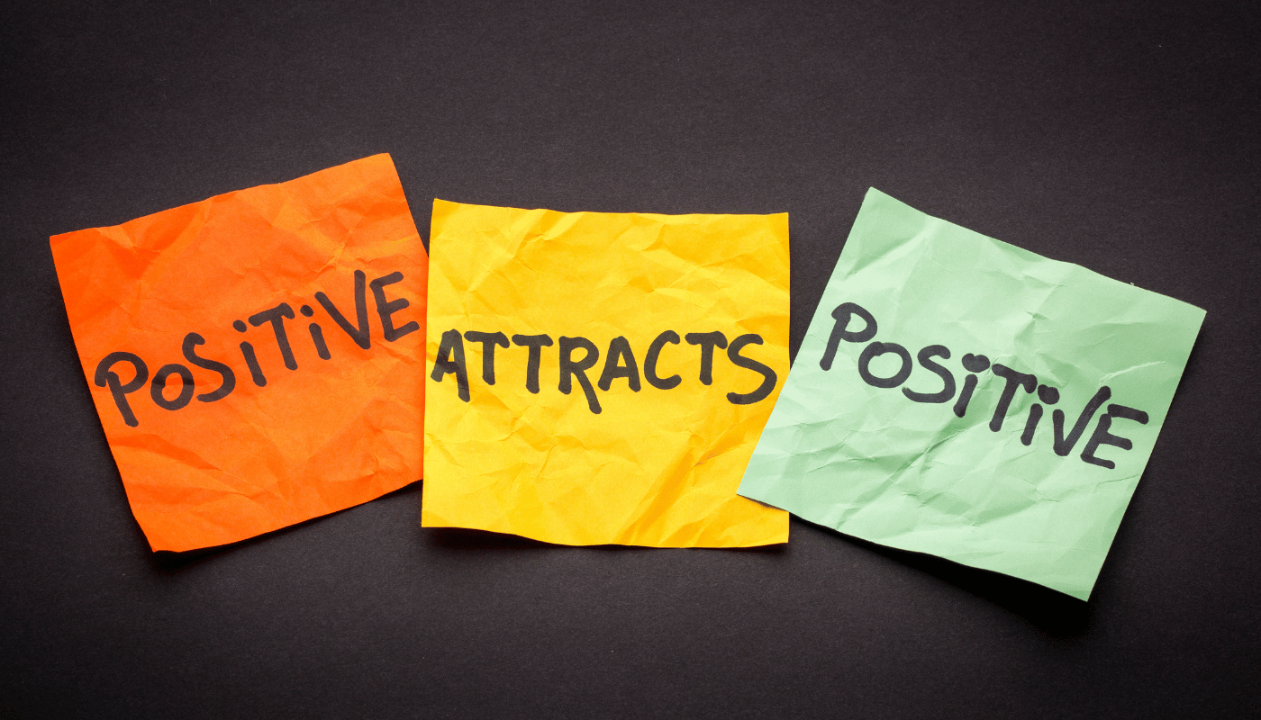 Three sticky notes with the words positive attracts positive written on them