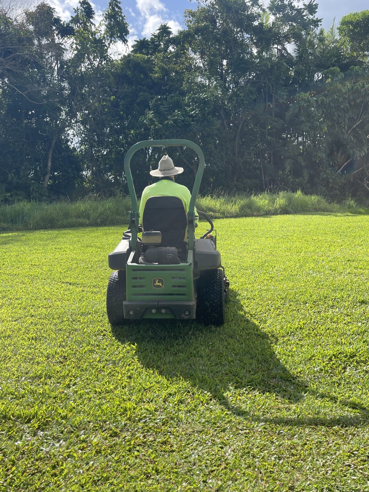Gardener on a Ride On Mower — Gardeners in Innisfail, QLD