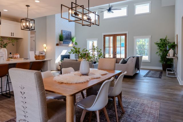 There is a dining table and chairs in the middle of the room.