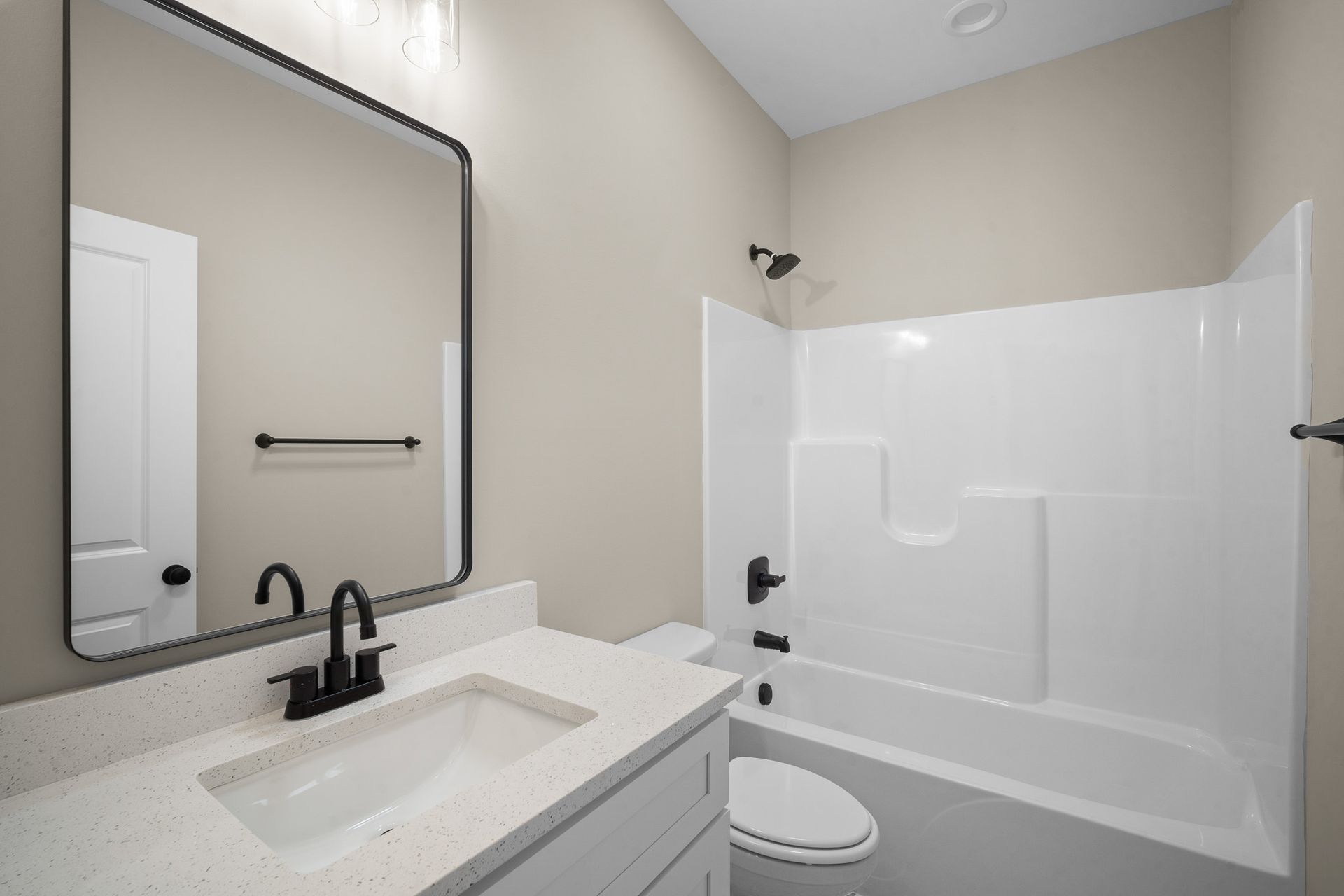 A bathroom with a sink , toilet , bathtub and mirror.