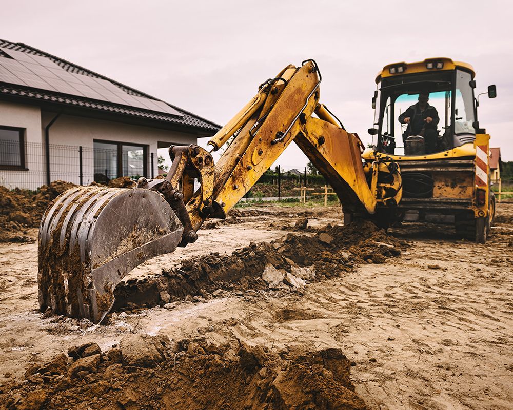 Worker Using Excavator Digging a Hole