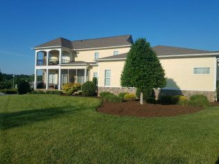 A large house with a large lawn in front of it.