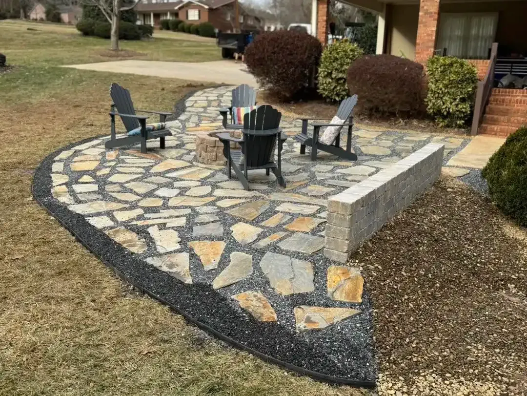 Completed stone paver patio with seating and a low retaining wall in Conover, NC