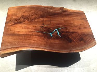 A wooden table with a hole in the middle of it.