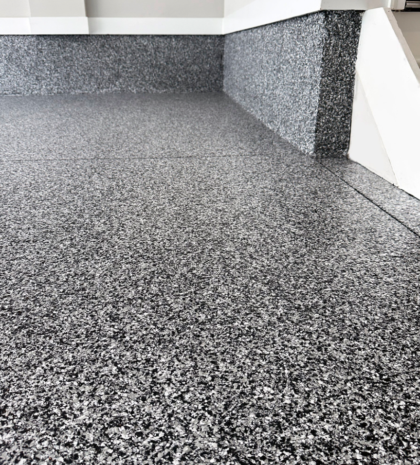 A close up of a gray carpeted floor in a room.