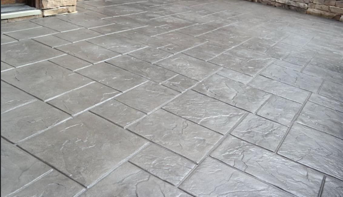 A close up of a concrete floor with a pattern on it.