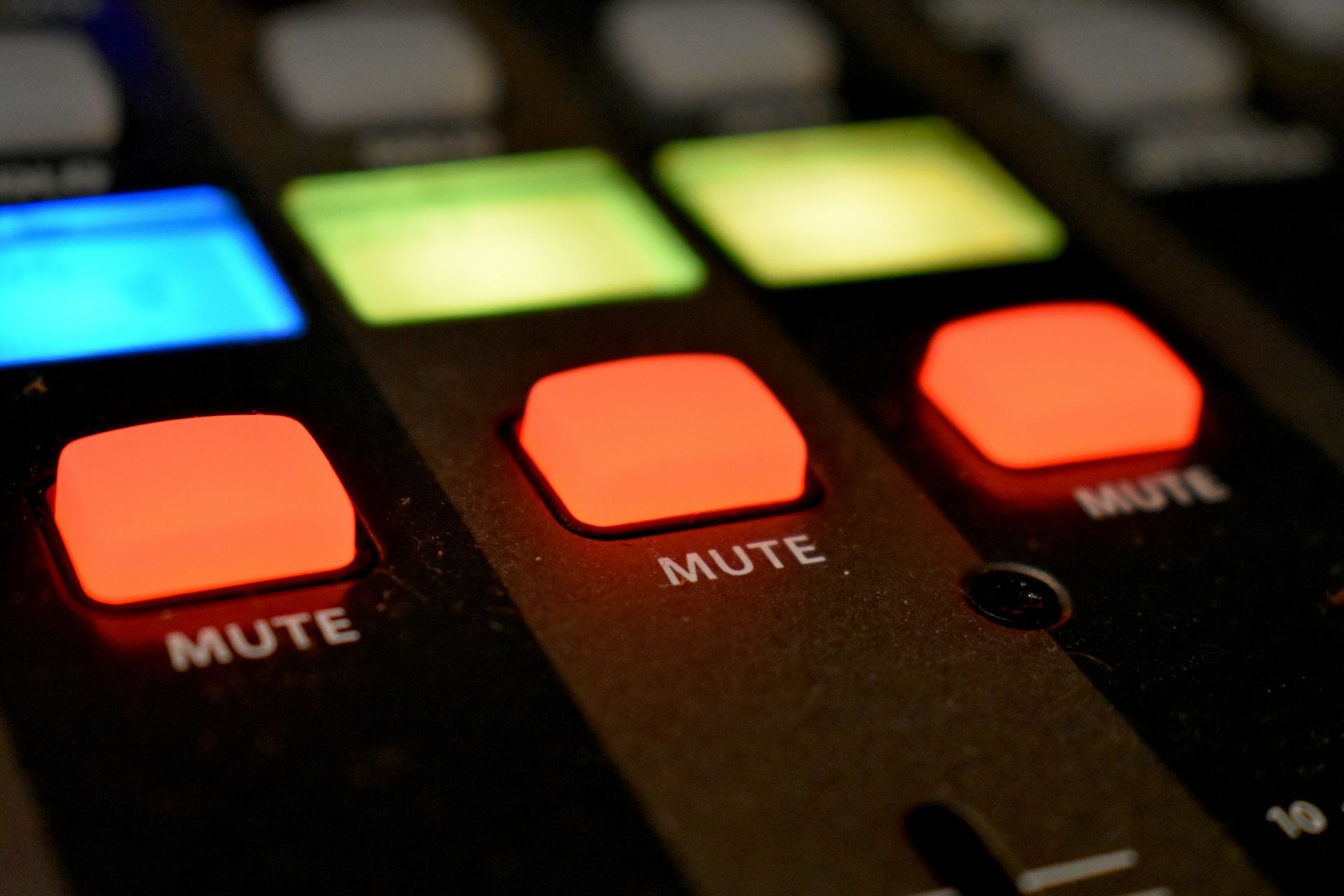 A close up of a mute button on a mixer