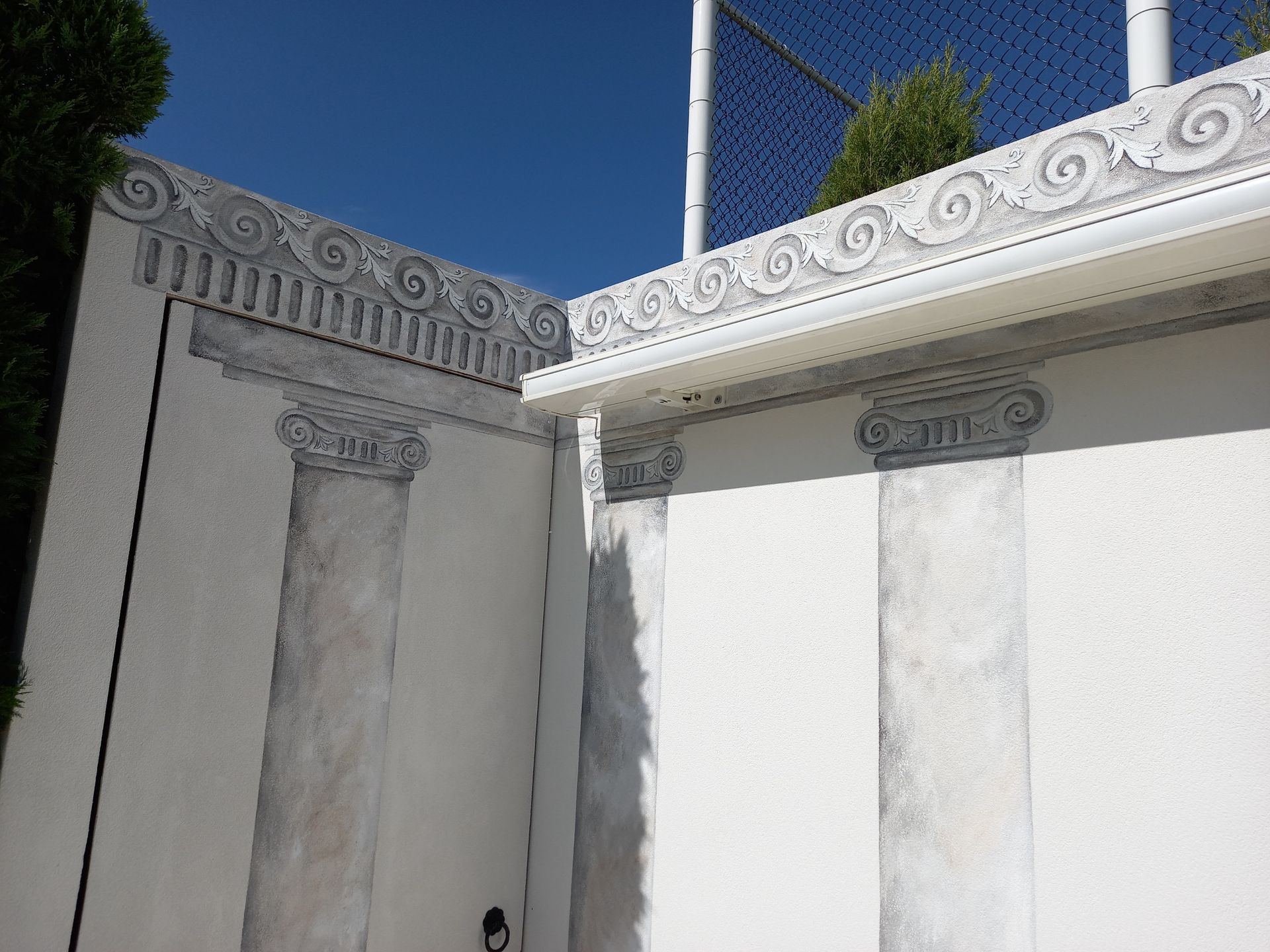 A white building with a blue sky in the background