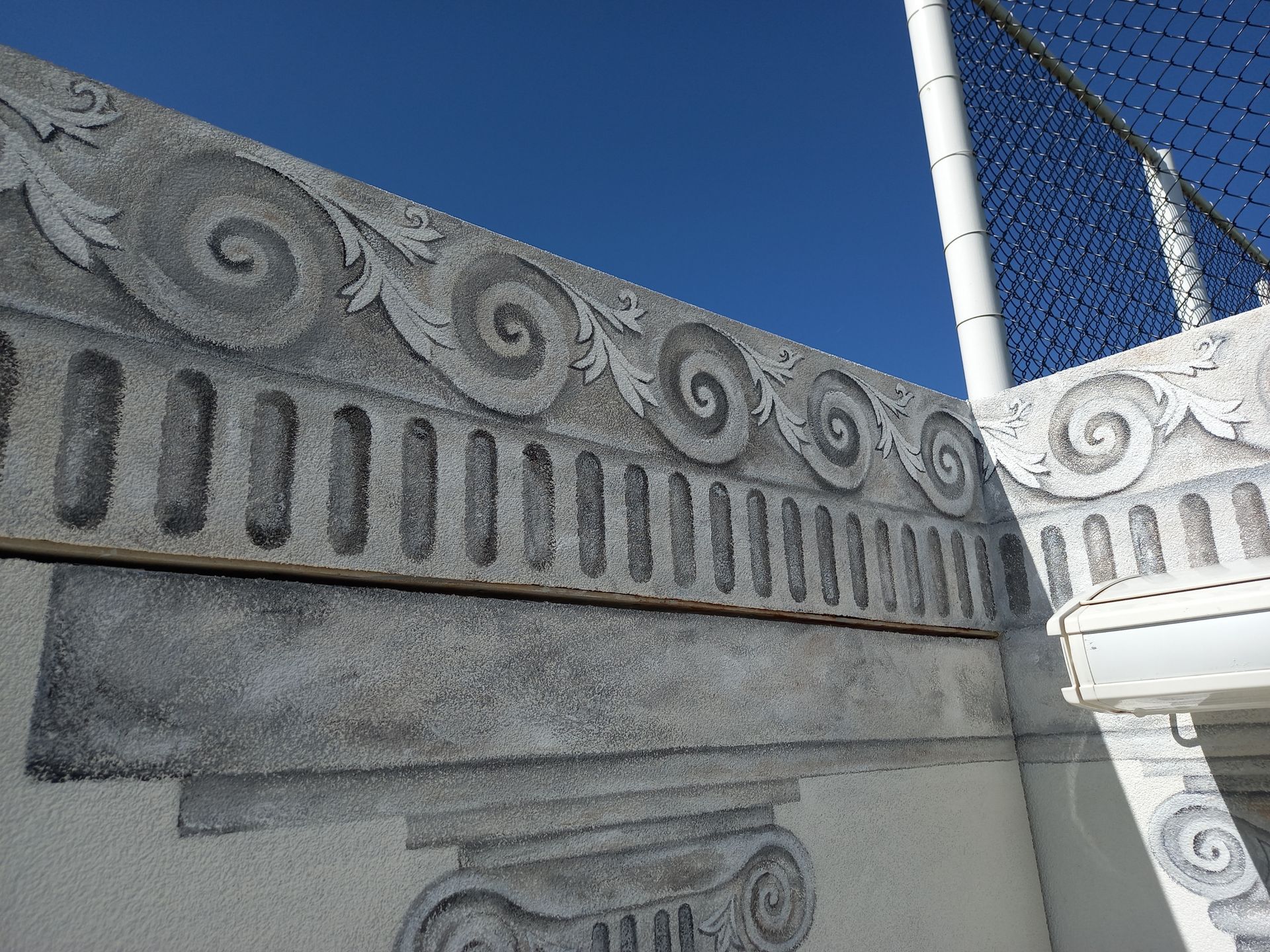 A stone wall with a blue sky in the background