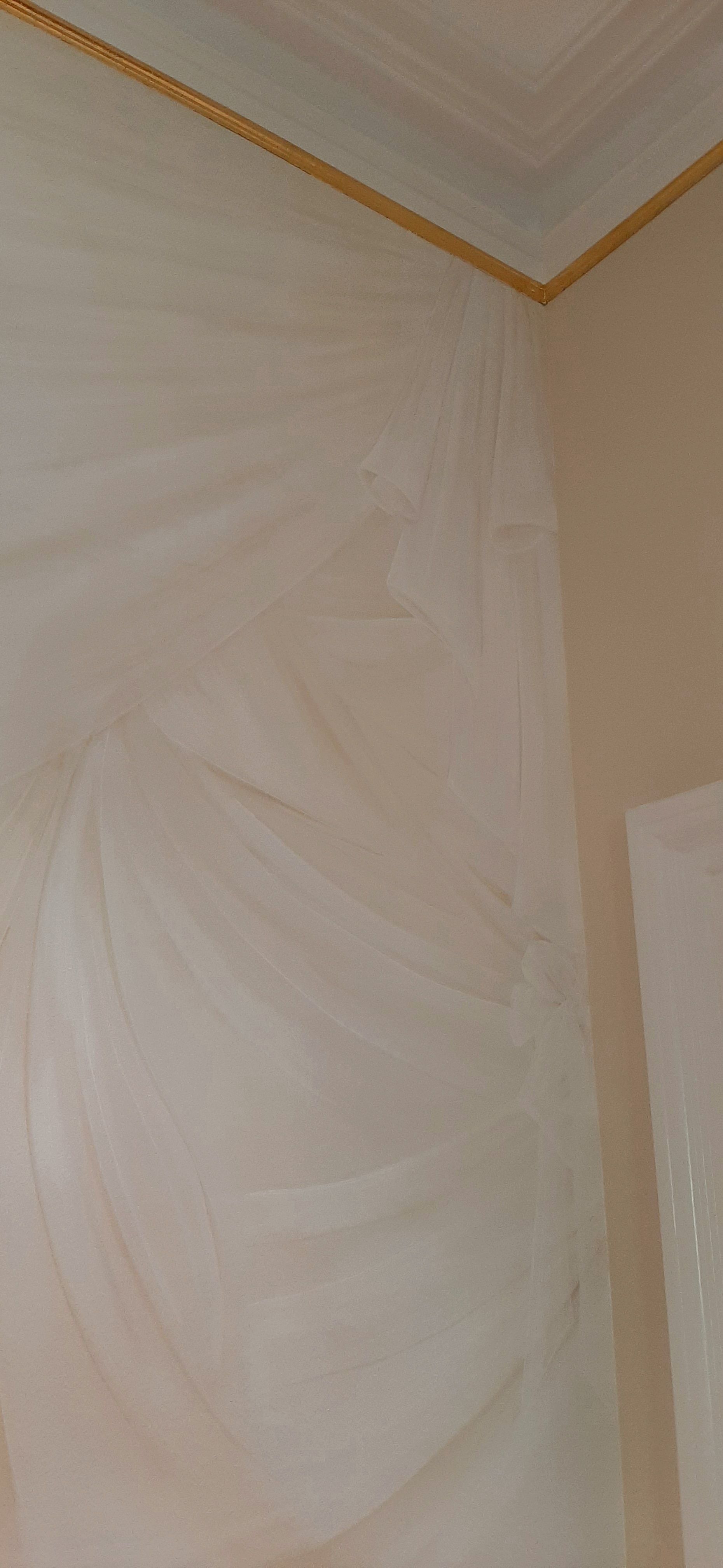 A room with a ceiling and a wall covered in plastic.