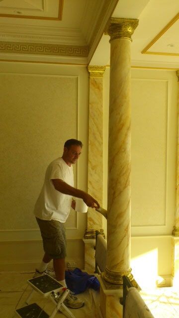 Man Paints The Column Post — Artizans International Specialised Paint Finishes in Robina, QLD