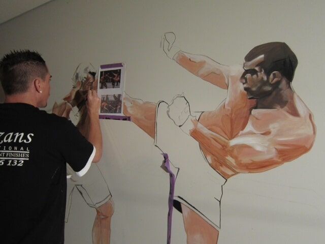 Man Paints On A Wall — Artizans International Specialised Paint Finishes in Robina, QLD