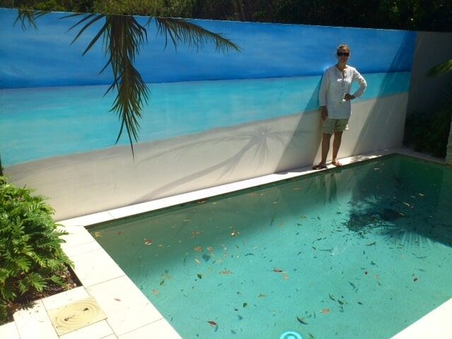 Woman Beside The Pool With Ocean Pool On The Wall — Artizans International Specialised Paint Finishes in Robina, QLD