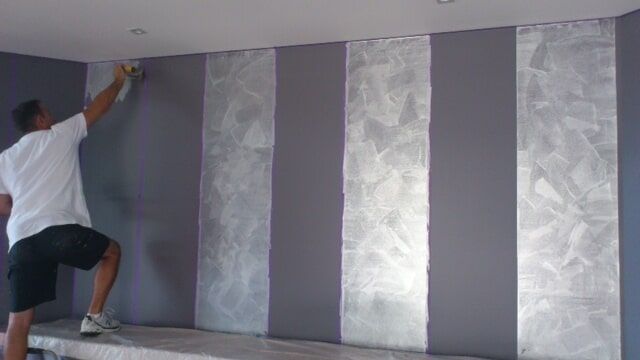 Man Paints The Wall In Metallic Design — Artizans International Specialised Paint Finishes in Robina, QLD