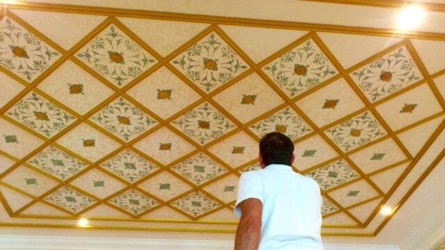 Man Looking At The Wall With Nice Stencils — Artizans International Specialised Paint Finishes in Robina, QLD