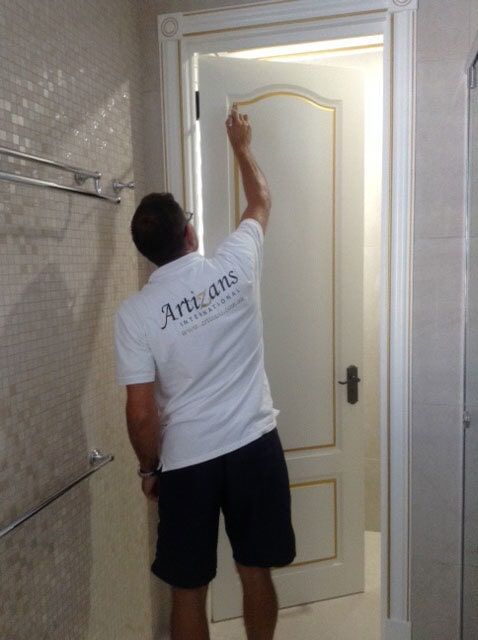 Man Paints A Metallic Gold To A Door — Artizans International Specialised Paint Finishes in Robina, QLD