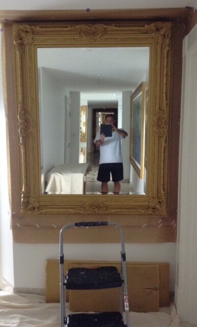 Man Taking A Picture Of The Gold Mirror — Artizans International Specialised Paint Finishes in Robina, QLD