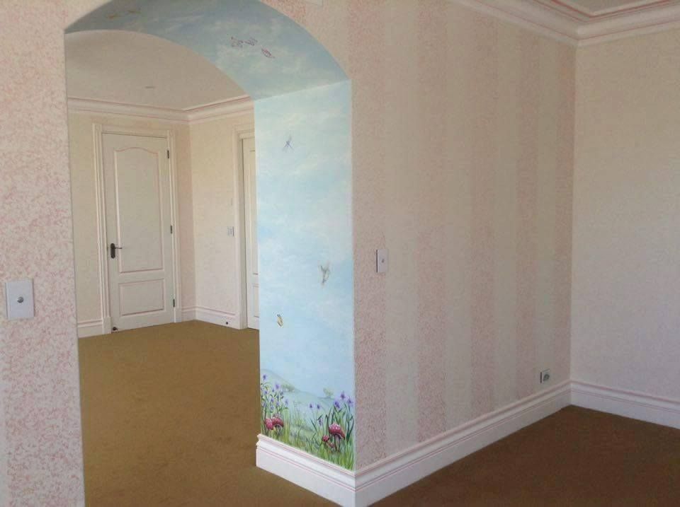 There is a painting on the wall in the corner of the room.
