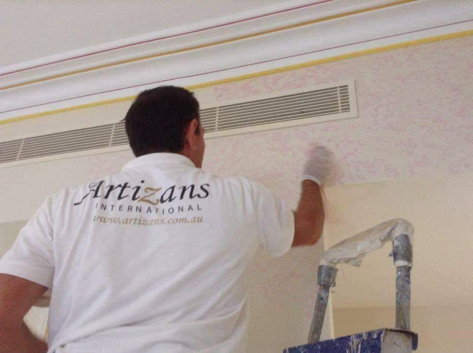 A man wearing a shirt that says artisans on it