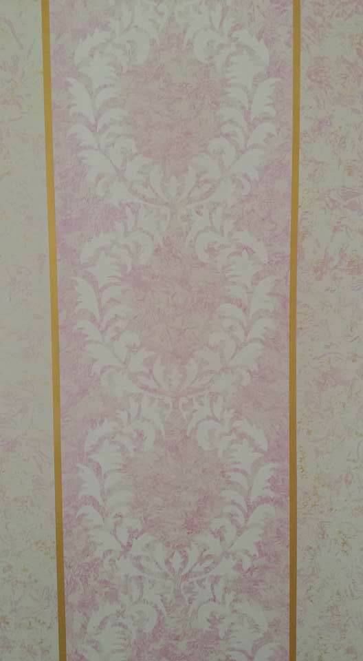 A close up of a pink and white striped wallpaper with a gold stripe.